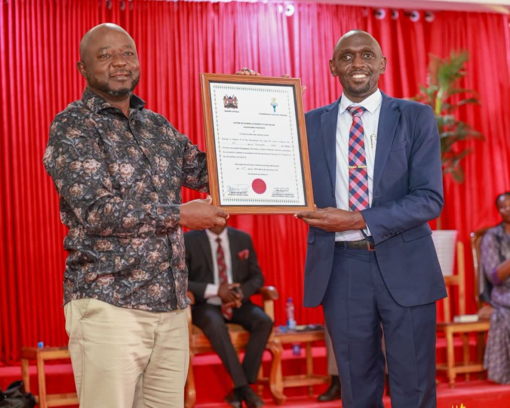 Two men holding a framed certificate at a ceremony with a red backdrop