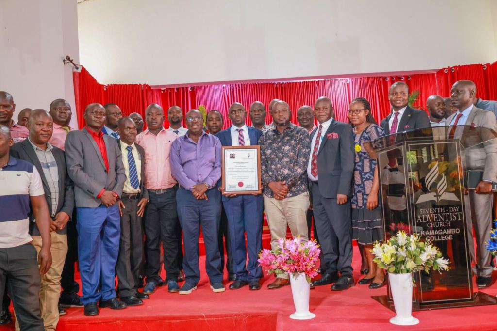A large group stands for a photograph at a certificate presentation